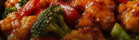 Glazed crispy chicken with broccoli and red pepper, a sample meal shown in the FEAST app